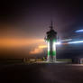 The lighthouse in the foggy night