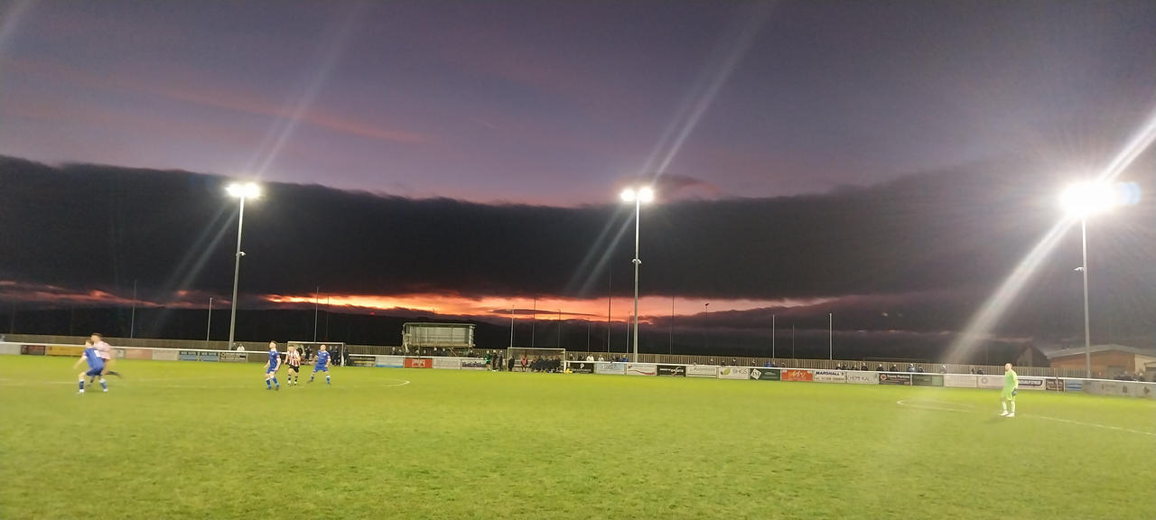 Sunset over a football match