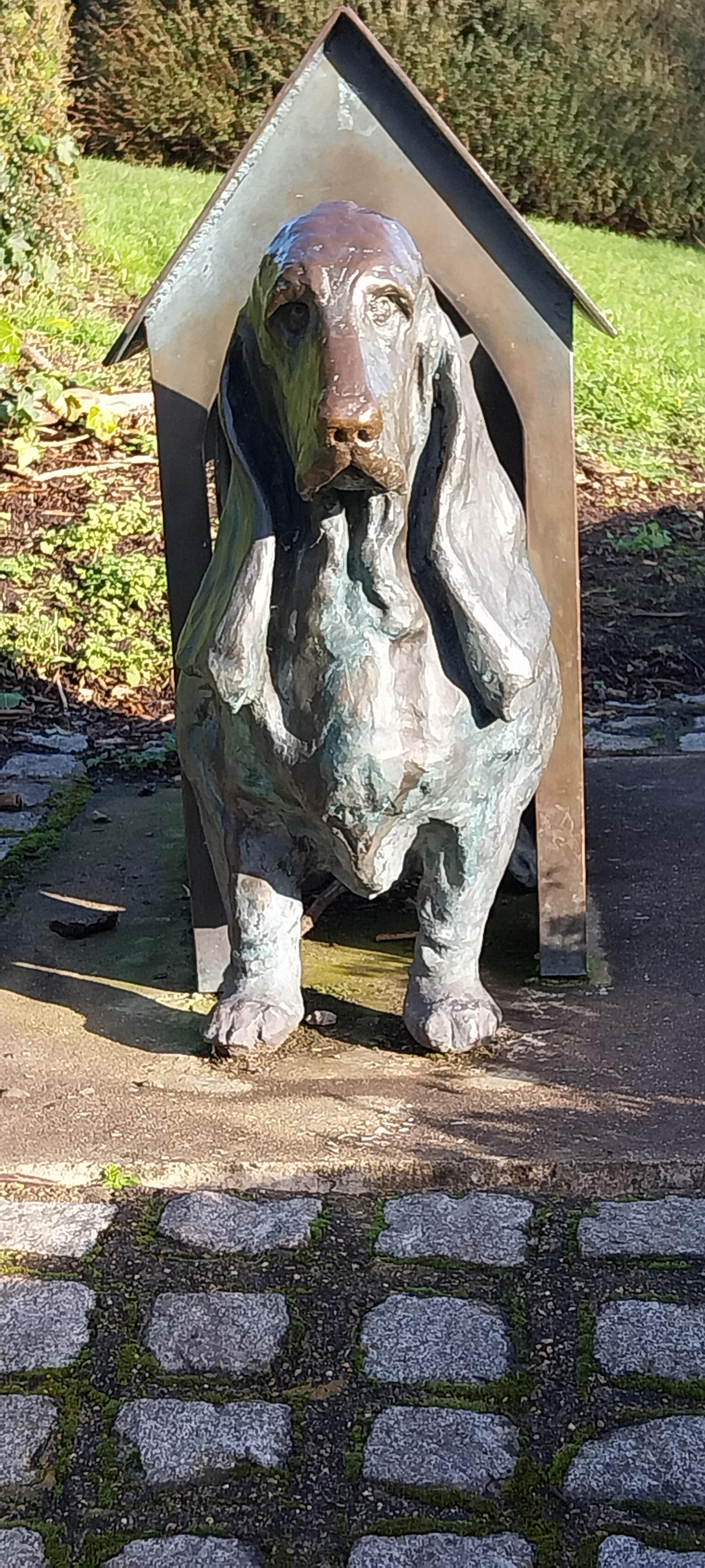 Dog in a doghouse bronze statue