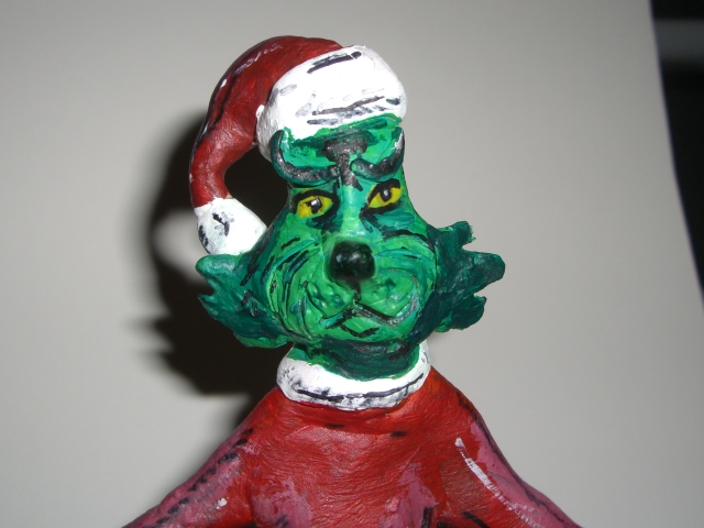 CLOSE UP ON grinch figurine