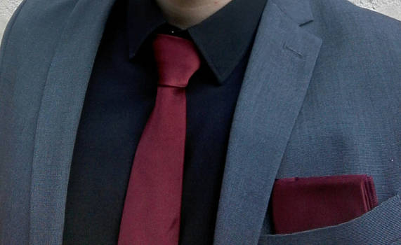 Grey suit, red details.