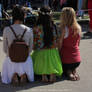 A barefoot girls at a city festival (c) FEET.SU