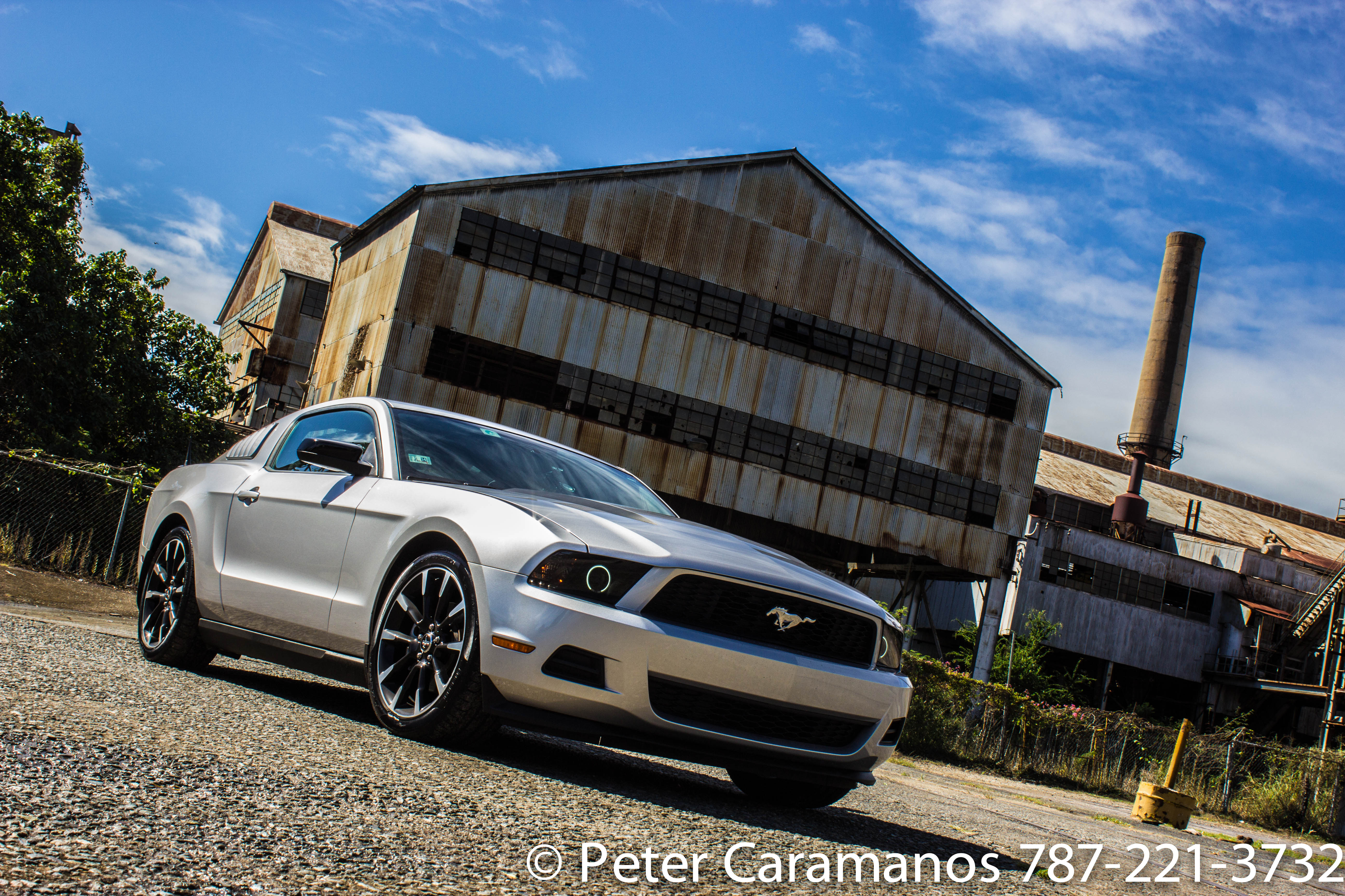 Blue Sky an old factory and a new Ford Mustang