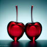 pair of cherries made of red crystal glass