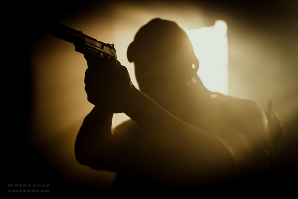 Backlit Man with Gun