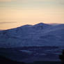 sunset over snowy mountains