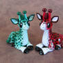 Red and green giraffe couple