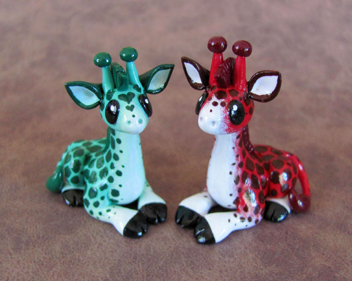 Red and green giraffe couple