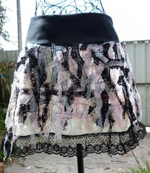 Skirt with sewn lace fabric
