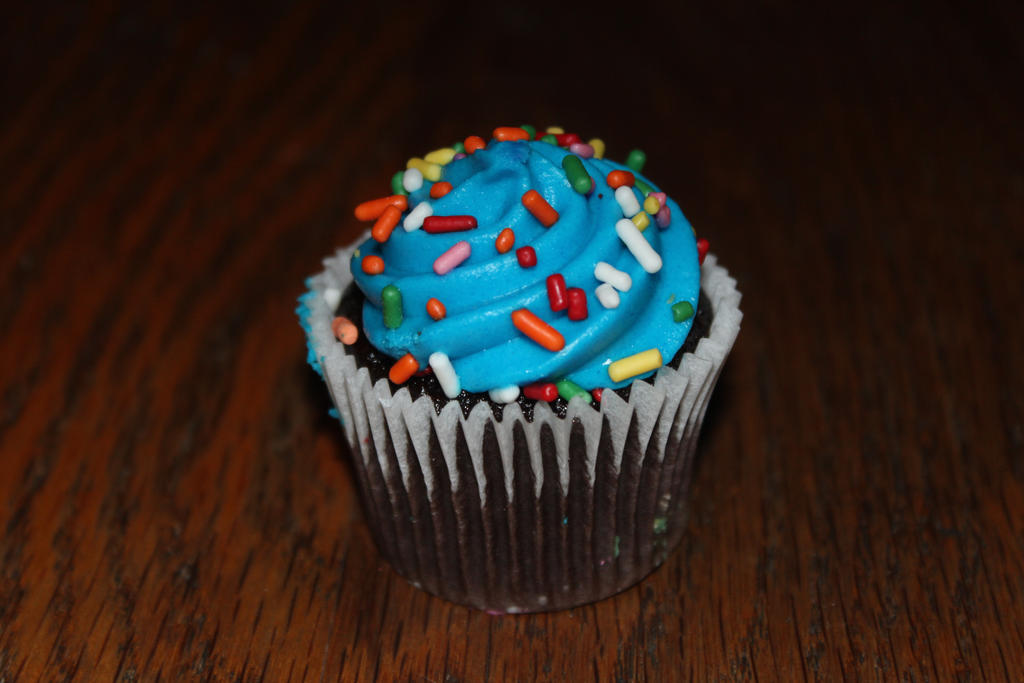 A mini cupcake with blue frosting