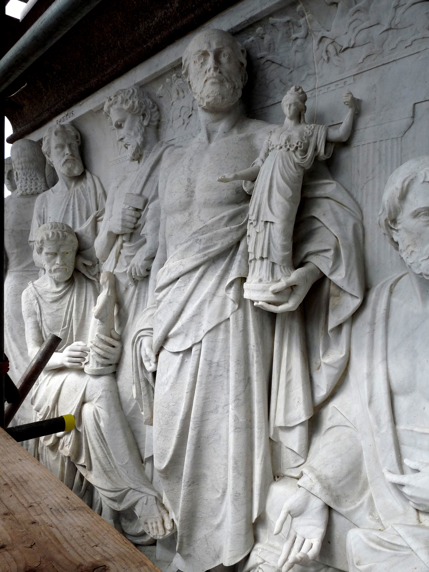 Phidias holding a figurine of Athena