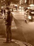 Man on street texting, waiting by SusanMMM