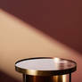 An Empty Round Side Table With Metallic Gold Rim (