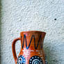 Charming terracotta jug with intricate designs sta