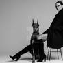 A woman with a Doberman A slender model with shar