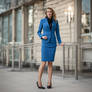 Alice wearing a blue pencil skirt suit with white