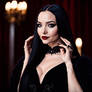 Dove Cameron as Morticia Addams, she wears a long