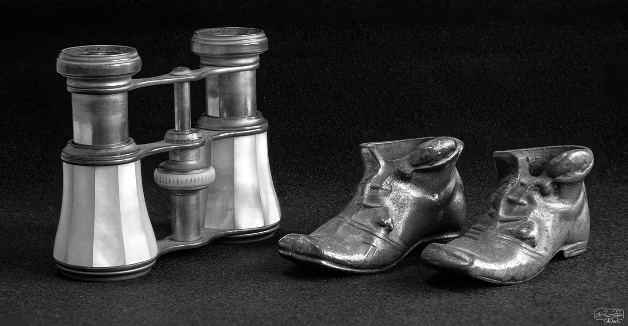Old binoculars and brass shoes