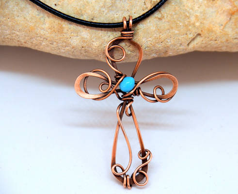Copper wire cross pendant with light blue bead