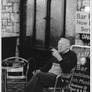 Old man smoking outside a pub