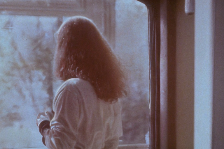 Frame-of-a-1980s-horror-movie-girl-standing-in-fro