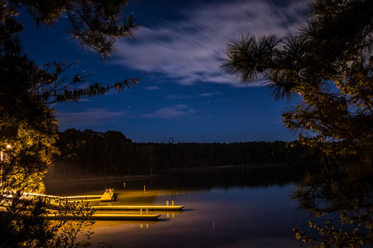 A lake and boat dock at night