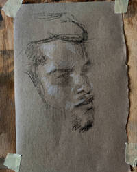 Quick portrait drawing with pencil on brown paper
