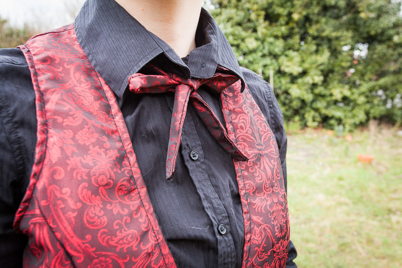 Red bustle ensemble - close up on cravat