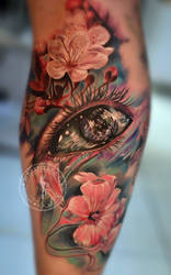 Surreal eye and flowers tattoo