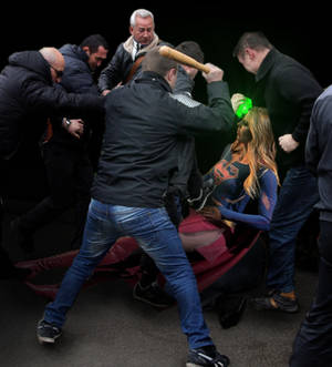 Supergirl is beaten by the mob