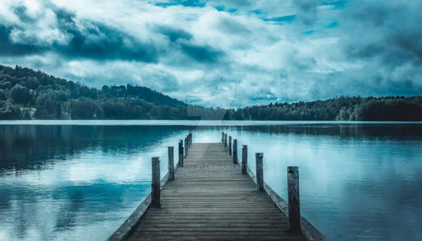 Peaceful landscape. Wooden pier leading into the o