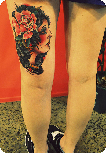 girl tattoo on thigh