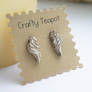 Distressed ivory angle wing ear studs