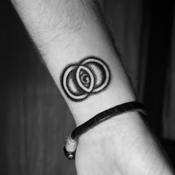 hand-poked vesica piscis tattoo