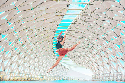 Ballerina jumping on Atyrau / Fish Bridge