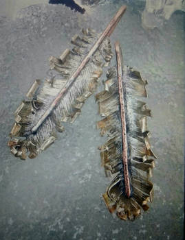 Hand cut silver feathers