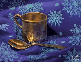 Silver spoon and cup still life