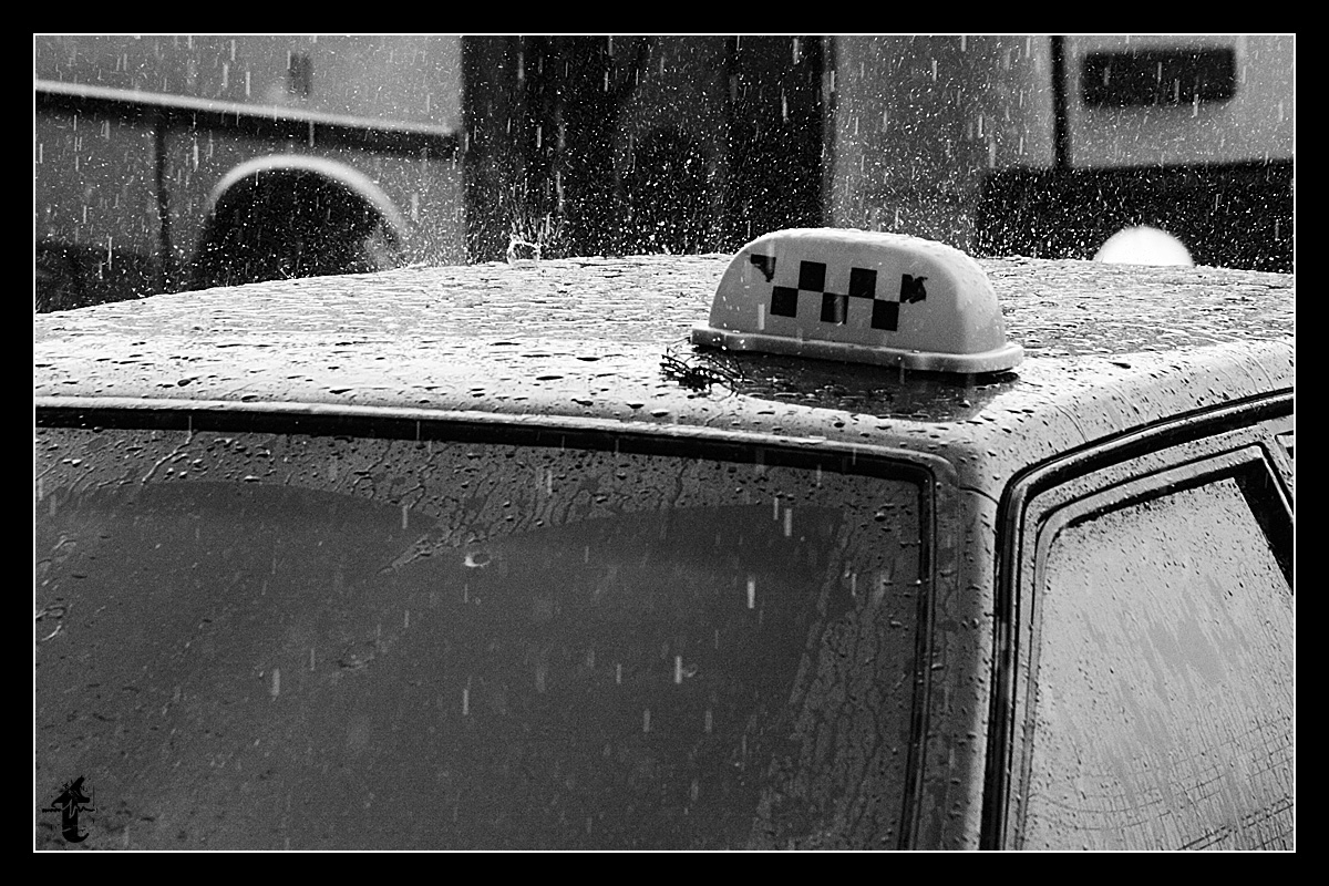 Yellow cab in monotone rain