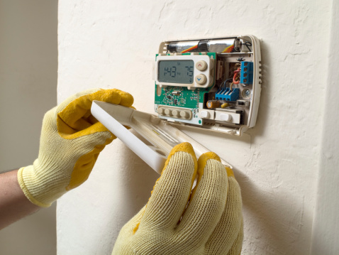 The hands of a Summerville Air Conditioning Repair