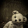 Sad stone teddy bear.