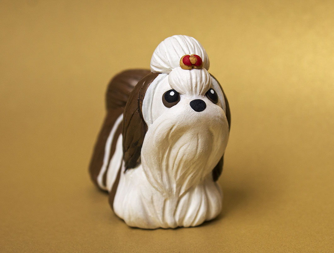 Brown and white Shih Tzu dog sculpture