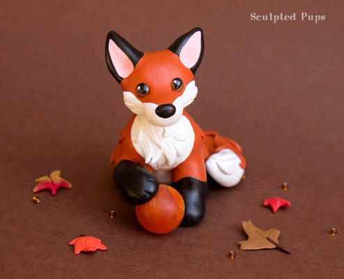 Red Fox with a fire sphere sculpture