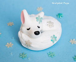 Sleeping white fox sculpture