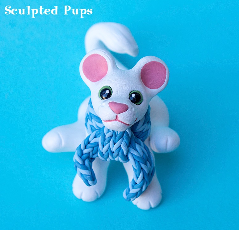 White lion cub sculpture with scarf