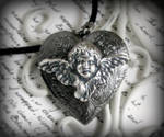 black cherub locket by JuleeMClark