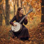 Photo of A female musician playing Banjo in an aut