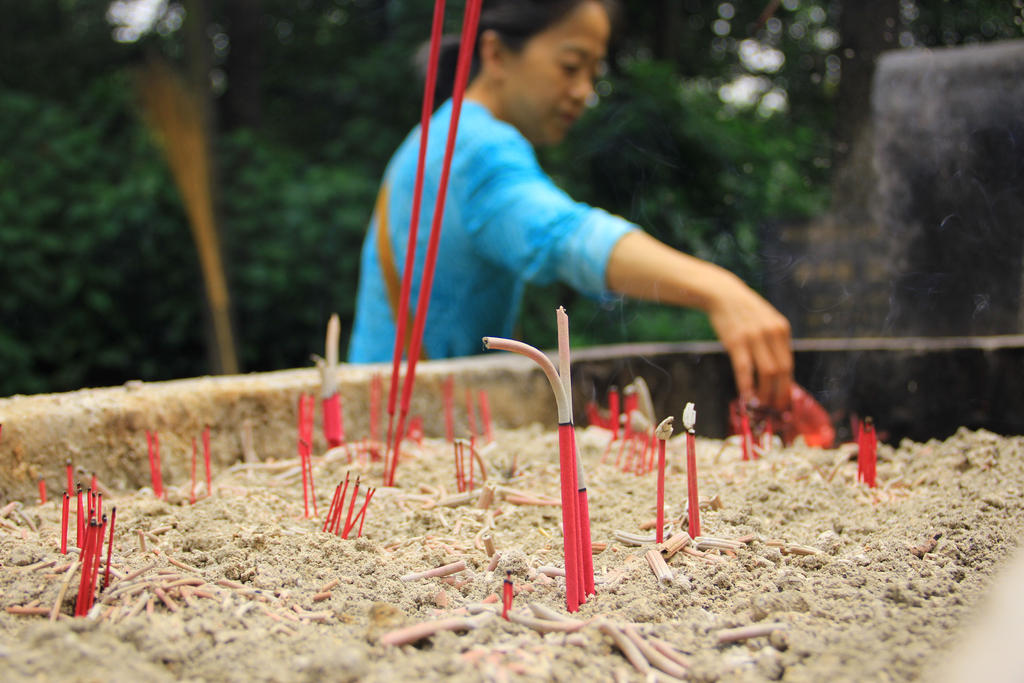 Woman lighting incense