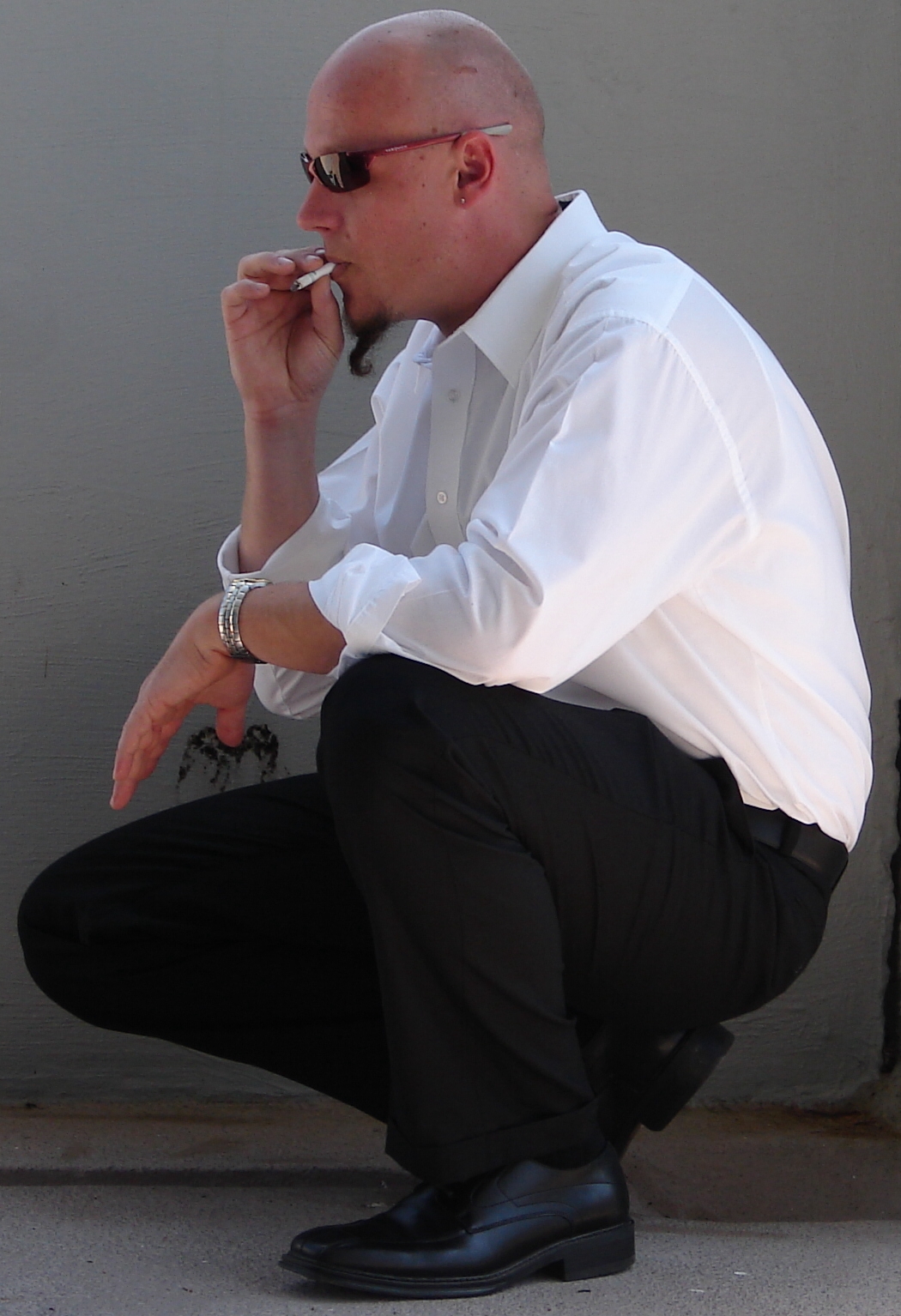 Cigarette Smoking Man Crouched by FantasyStock