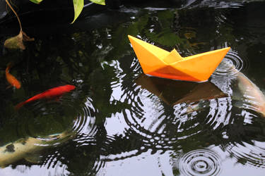 Origami boat on the water