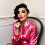 A drag queen in a pink satin blouse with black hai